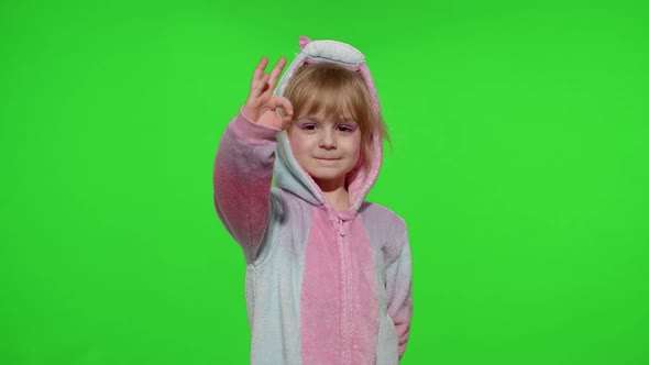 Little Child Girl Smiling Showing Thumbs Up Ok Gesture Agree Sign in Unicorn Pajama on Chroma Key