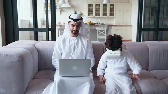 Arabian father and son on the couch