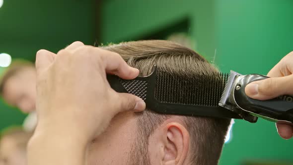 Barber Hands Make Haircut Holding Hair Clipper and Comb