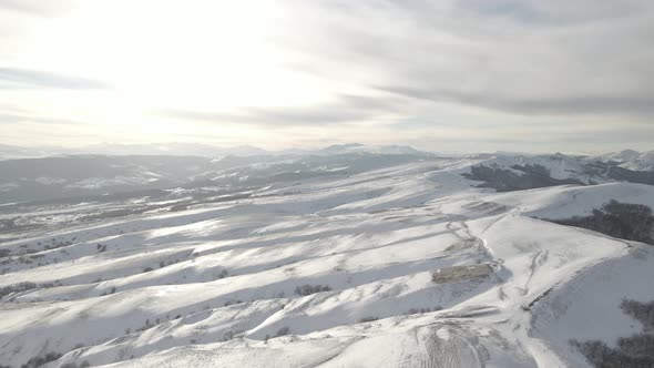 Snowy mountain landscape, aerial view of mountains at sunset near Didgori. Nichbisi. Georgia 2021