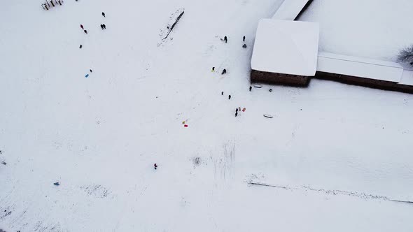 People enjoying winter snowy slides near Kaunas city castle