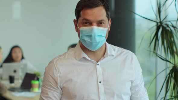 Portrait of Successful Young Businessman Wearing Protective Face Mask Looking Into Camera in