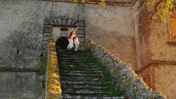 Young girl on the entrance stairway to the castle