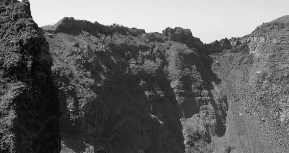 Panning along the huge crater of the Mount Vesuvius volcano in black and white in Pompeii, Italy.