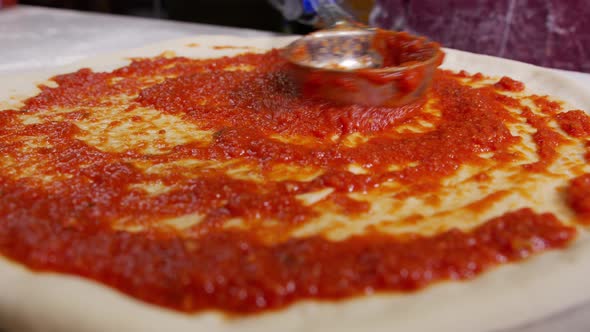 Close Up Chef Is Spreading Tomato Sauce Pizza Dough Metal Ladle Traditional Italian Pizza