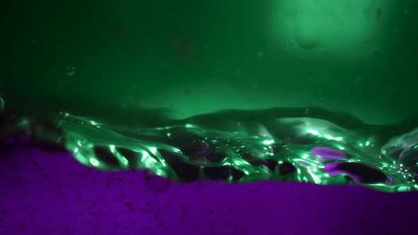 Beautiful Mix of Green and Purple Liquids of Different Densities in Aquarium