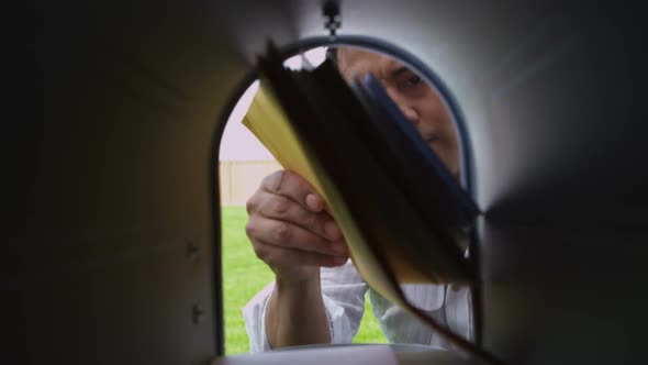 Man opens mailbox and gets letters