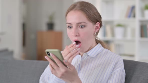 Portrait of Young Woman Reacting to Loss on Smartphone