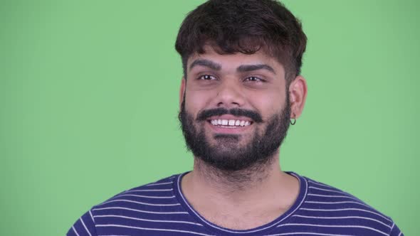 Face of Happy Young Overweight Bearded Indian Man Waving Hand