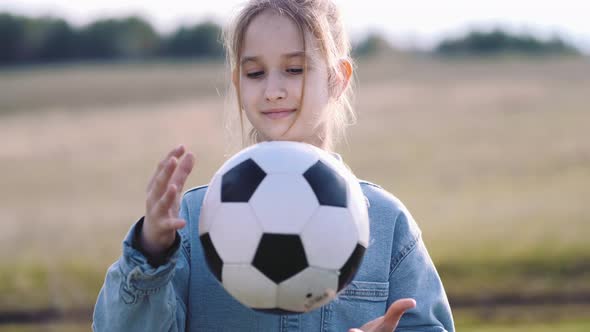 Teenager Girl Play Soccer Ball on Grass in Park