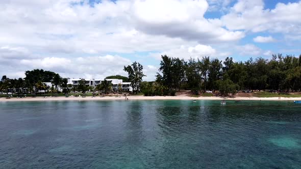 Slow forward aerial of sandy beach,turquoise water and luxus resort,mauritius