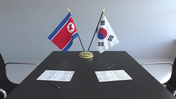 Flags of North Korea and South Korea on the Table