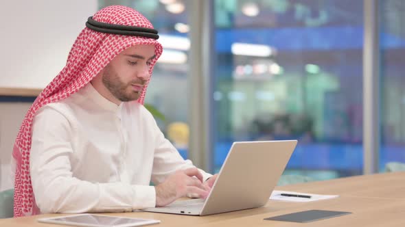 Serious Arab Businessman Working on Laptop in Office