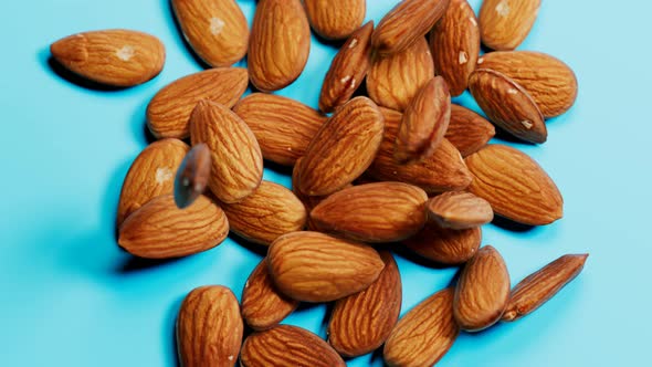Almonds are falling down and forming a shape of the hart. The tasty crunchy nuts