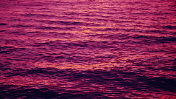 Purple Afterglow on Waves after a Sea Sunset 4k