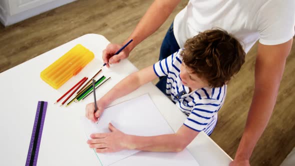 Father helping son with homework