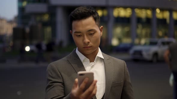 Locked Down Real Time Portrait Shot of a Young Businessman Conducting Correspondence on the Phone.