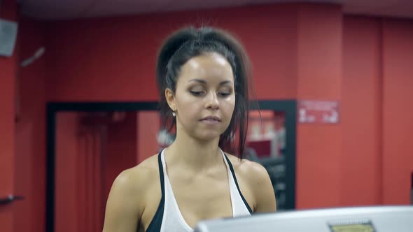 Close View Girl Turns on Treadmill and Starts Running