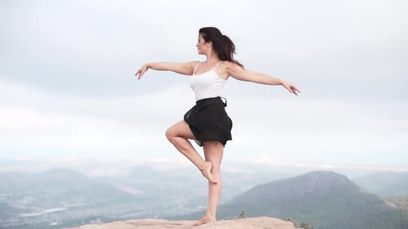 Graceful female dancing in countryside