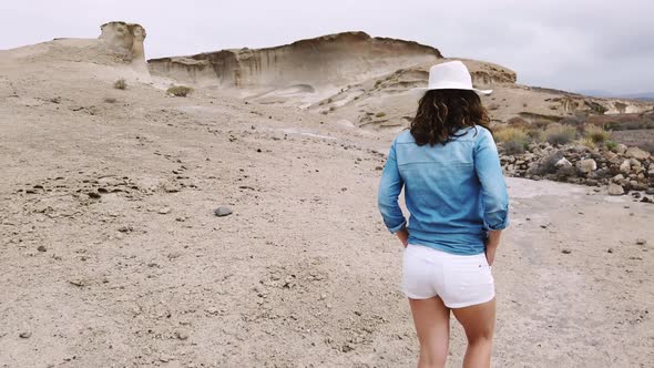 Female tourist walking on sandy quarry