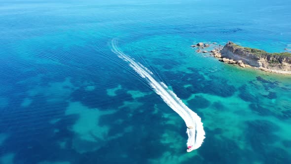 Aerial View of a Motor Boat Towing a Tube. Zakynthos, Greece