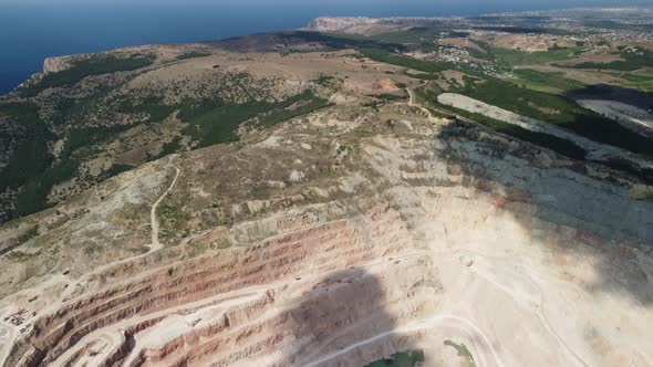 Aerial View Industrial of Opencast Mining Quarry with Lots of Machinery at Work Extracting Fluxes