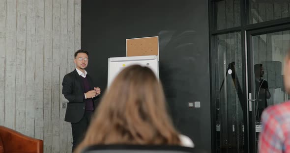 Businessman Giving a Presentation to Colleagues in the Office