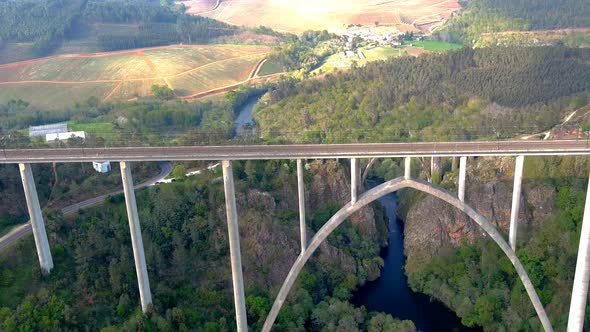 Aerial Flying Over New Ulla Viaduct With Old Gundian Bridge Behind It. Dolly Forward, Tilt Down