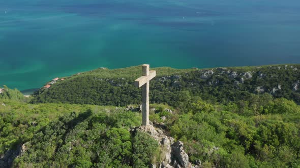 Aerial View of the Concrete Cross with the Coastal Scenery in the Background