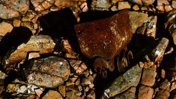 Abandoned Rusty Mine Cart on Rocks alt