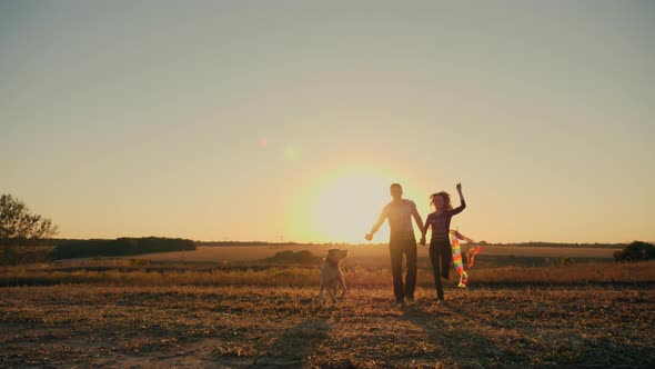 Beauty Young Couple with Dog Running with Kite