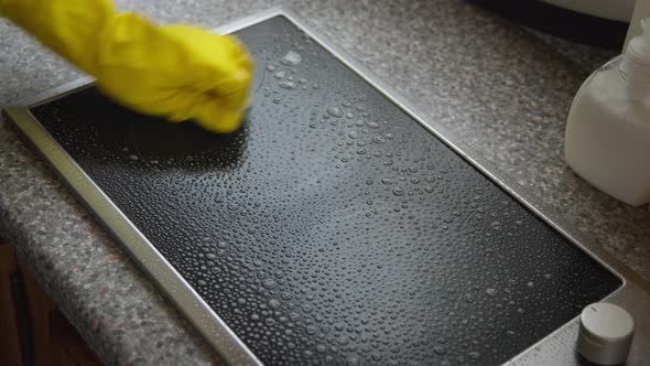 Close-up Cleaning Kitchen Worktop, Polishing Glass with Microfiber Cloth