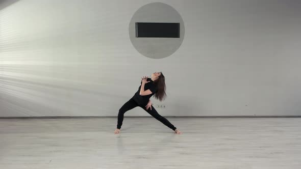 Woman Performing Modern Dance on Studio Background