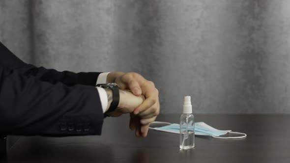 Man Using Bottle of Liquid Alcohol Spray Sanitizer with Hands. Coronavirus