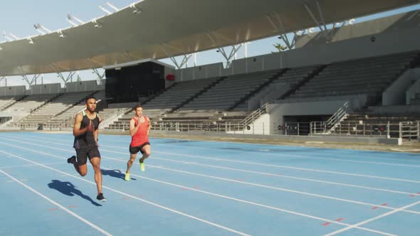 Two athletes running in stadium