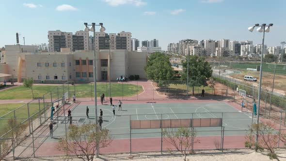 basketball  playground at the high school , shot from above with drone, at southern district city in