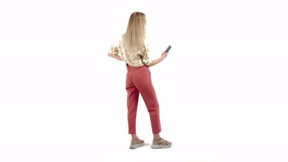 Cute Caucasian Blueeyed Blonde Girl with Pretty Smile Wearing Shirt and Pink Trousers Standing