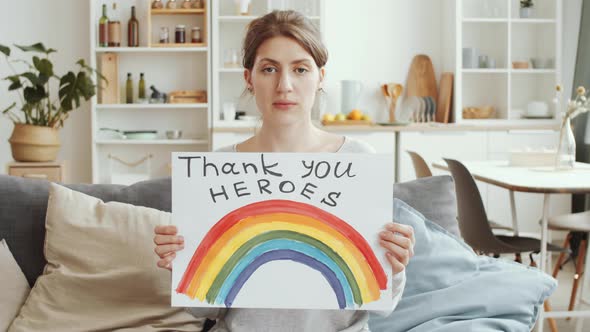 Woman Posing with Poster with «NHS thank you heroes» Sign and Rainbow