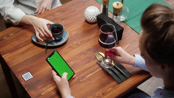 Woman Using Smartphone with Chroma Green Screen and Drinking Red Wine Qr Code with Online Menu in