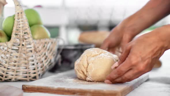 Housewife Hands Applying Flour Kneading Dough on Wooden Board