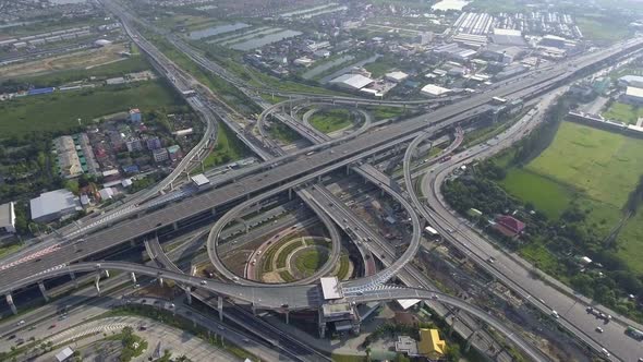 Aerial View of Highway Road Interchange with Busy Urban Traffic Speeding on Road