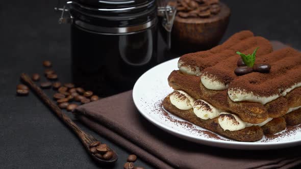 Classic Tiramisu Dessert and Coffee Grinder on Ceramic Plate on Concrete Background