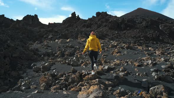 Woman Traveler Walks Through the Lava Field Around Chinyero Volcano in the Teide National Park on