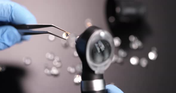 Gloved Jeweler Holds Tweezers with Gem and Examines Through Magnifying Glass Slow Motion  Movie