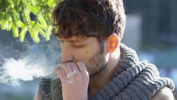 Close up of a smoking man