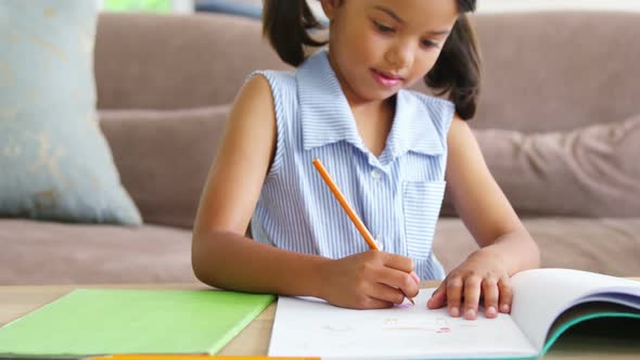 Girl doing homework in living room