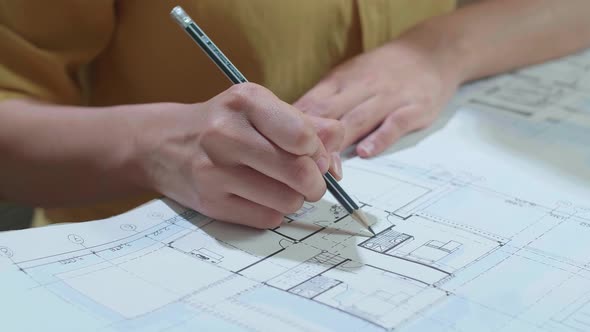 Close Up Of Hand's Woman Engineer Drawing Blueprint