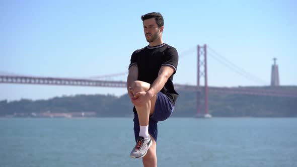 Athletic Man Stretching Leg at Riverside