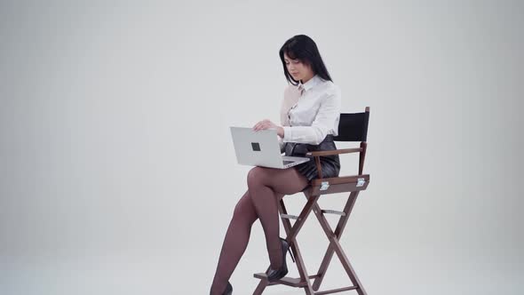 Sexy young lady open laptop in studio