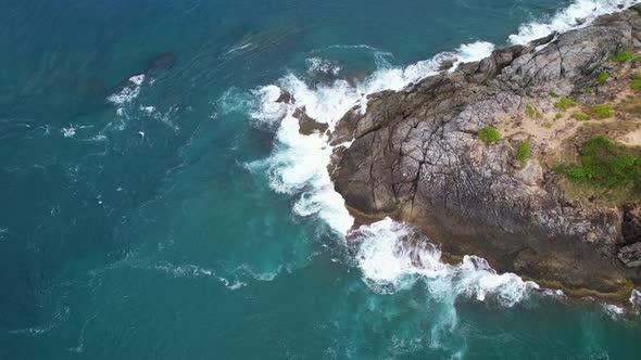 Aerial view phuket seashore Wave crashing on rocks at Laem promthep cape beautiful sea in Phuket